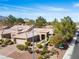 Inviting single-story residence showcasing a well-kept garden and a stylish brick driveway at 9300 Villa Ridge Dr, Las Vegas, NV 89134