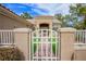 A gated front yard with stucco pillars, a tiled walkway, and artificial grass inside the gate at 9300 Villa Ridge Dr, Las Vegas, NV 89134