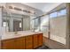 An elegant bathroom featuring double sinks, a large mirror, and a tiled shower-tub combo at 9995 Yellow Canary Ave, Las Vegas, NV 89117