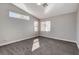 A spacious bedroom bathed in natural light with a large window and plush gray carpet at 9995 Yellow Canary Ave, Las Vegas, NV 89117