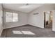 A bright bedroom with a view and a built-in TV mount, paired with cozy gray carpet at 9995 Yellow Canary Ave, Las Vegas, NV 89117