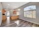 Eat-in kitchen features a peninsula, wood floors, and natural light from the window at 9995 Yellow Canary Ave, Las Vegas, NV 89117