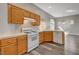 Kitchen with wood cabinets, white appliances, neutral countertops and wood flooring at 9995 Yellow Canary Ave, Las Vegas, NV 89117