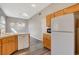 Spacious kitchen with wood cabinets, white appliances and neutral countertops at 9995 Yellow Canary Ave, Las Vegas, NV 89117