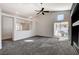 Bright living room with neutral carpet and a sliding glass door to the backyard at 9995 Yellow Canary Ave, Las Vegas, NV 89117