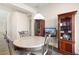 Small dining area featuring tile flooring, a chandelier, and custom wood cabinetry at 3992 Welsh Pony St, Las Vegas, NV 89122