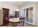 Bright dining area features a stone table, wood furnishings, and natural light from the sliding glass doors at 3992 Welsh Pony St, Las Vegas, NV 89122