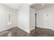 Neutral-colored hallway with tile floors, white doors, and a window with white shutters at 3992 Welsh Pony St, Las Vegas, NV 89122