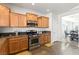 Well-lit kitchen offers stainless steel appliances, granite counters and a view to the dining area at 3992 Welsh Pony St, Las Vegas, NV 89122