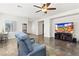 Open-concept living room with tile flooring, a comfortable recliner, and a large TV at , Las Vegas, NV 89122