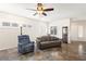 Cozy living room with neutral colors, tile floors, and a ceiling fan with a light fixture at 3992 Welsh Pony St, Las Vegas, NV 89122