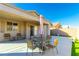 Outdoor patio with dining set, chairs, and well-maintained artificial turf at , Las Vegas, NV 89122