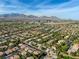 Breathtaking aerial view of the neighborhood with stunning mountain backdrop on a clear day at 10528 Meadow Mist Ave, Las Vegas, NV 89135