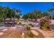 Inviting backyard with a rock-adorned pool, a cozy fire pit area, and manicured landscaping for ultimate relaxation at 10528 Meadow Mist Ave, Las Vegas, NV 89135