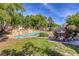 Lush backyard featuring a sparkling swimming pool with a rock waterfall, complemented by an inviting outdoor seating area at 10528 Meadow Mist Ave, Las Vegas, NV 89135