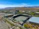 Aerial view of a baseball stadium set against mountains and cityscape with parking and landscaping at 10528 Meadow Mist Ave, Las Vegas, NV 89135