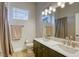 Well-lit bathroom with double sinks, modern lighting, and a large mirror at 10528 Meadow Mist Ave, Las Vegas, NV 89135