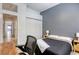 Bedroom with a gray accent wall and a view of the hallway through an arched doorway at 10528 Meadow Mist Ave, Las Vegas, NV 89135