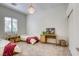 Bright bedroom with twin beds and a desk setup by the window at 10528 Meadow Mist Ave, Las Vegas, NV 89135