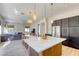 Modern kitchen featuring an island with seating, stainless steel appliances, and granite countertops at 10528 Meadow Mist Ave, Las Vegas, NV 89135