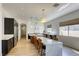 Modern kitchen featuring an island with seating, stainless steel appliances, and granite countertops at 10528 Meadow Mist Ave, Las Vegas, NV 89135