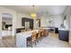 Modern kitchen featuring an island with seating, stainless steel appliances, and granite countertops at 10528 Meadow Mist Ave, Las Vegas, NV 89135