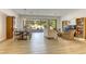 Bright and airy living room featuring an open floor plan, hardwood floors, and sliding doors to the patio at 10528 Meadow Mist Ave, Las Vegas, NV 89135