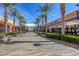 Open-air shopping center featuring palm trees, pedestrian walkways, and various retail stores at 10528 Meadow Mist Ave, Las Vegas, NV 89135