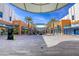 Outdoor shopping center with palm trees, pedestrian walkways, and a Macy's department store at 10528 Meadow Mist Ave, Las Vegas, NV 89135