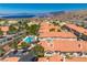 Stunning aerial view of the condos featuring a pool, mountains, and a glimpse of the lake at 107 Topsail Dr, Boulder City, NV 89005