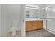 Bright bathroom featuring double vanity, wood cabinets and glass shower with a clean, modern design at 107 Topsail Dr, Boulder City, NV 89005