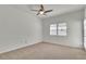 Bedroom with neutral carpet, ceiling fan, and natural light at 107 Topsail Dr, Boulder City, NV 89005