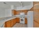 Bright kitchen features wood cabinets, white appliances, and tile flooring at 107 Topsail Dr, Boulder City, NV 89005