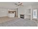 Cozy living room with a fireplace, bright kitchen, and natural light at 107 Topsail Dr, Boulder City, NV 89005