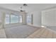 Bright living room with neutral walls, ceiling fan, and large windows creating an airy atmosphere at 107 Topsail Dr, Boulder City, NV 89005