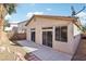 A view of the backyard featuring a concrete patio, stucco walls, and a palm tree at 10765 Muscari Way, Las Vegas, NV 89141