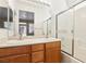 Bright bathroom with double sink vanity, framed mirror and combined shower and tub at 10765 Muscari Way, Las Vegas, NV 89141