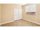 Bedroom with closet with sliding doors, neutral walls, and tile floors at 10765 Muscari Way, Las Vegas, NV 89141