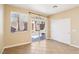 Bright bedroom featuring tile floors, a sliding glass door to the yard, and white closet doors at 10765 Muscari Way, Las Vegas, NV 89141