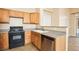 Well-equipped kitchen featuring wood cabinets and a stainless steel dishwasher at 10765 Muscari Way, Las Vegas, NV 89141