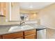 Functional kitchen showcases a convenient breakfast bar and stainless steel dishwasher at 10765 Muscari Way, Las Vegas, NV 89141