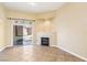 Cozy living room corner featuring fireplace and sliding glass door access to backyard at 10765 Muscari Way, Las Vegas, NV 89141