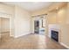 Bright living room featuring tile flooring, a fireplace, and a sliding door to the backyard at 10765 Muscari Way, Las Vegas, NV 89141