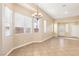 Open living room with lots of windows, neutral walls, and tile floors at 10765 Muscari Way, Las Vegas, NV 89141