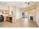 Bright living space with a fireplace, tile flooring, and an open layout leading to the kitchen at 10765 Muscari Way, Las Vegas, NV 89141