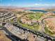 Stunning aerial view of houses with golf course and water at 108 Kimberlite Dr, Henderson, NV 89011