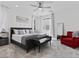 Bright bedroom featuring a gray bed, soft bench and red chair at 108 Kimberlite Dr, Henderson, NV 89011