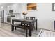 Dining area open to a modern kitchen, featuring stainless steel appliances and bright white cabinets at 108 Kimberlite Dr, Henderson, NV 89011