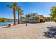 Charming lakeside view with an outdoor seating area, palm trees, and lovely surroundings at 108 Kimberlite Dr, Henderson, NV 89011