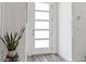 Bright entryway features frosted front door, light grey wood-look floors and white walls at 108 Kimberlite Dr, Henderson, NV 89011